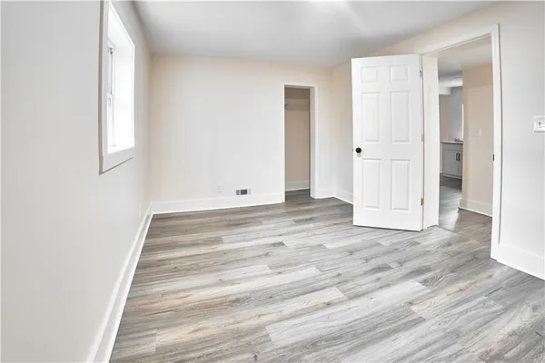 a view of an entryway with wooden floor