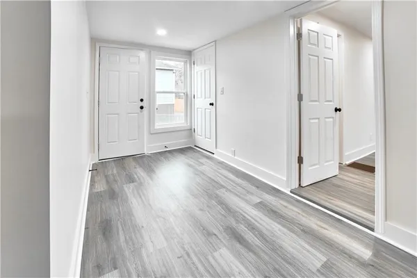 a view of a hallway with wooden floor