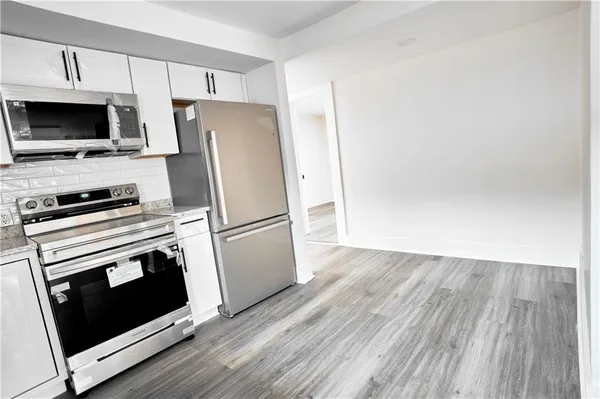 a kitchen with a refrigerator stove and microwave