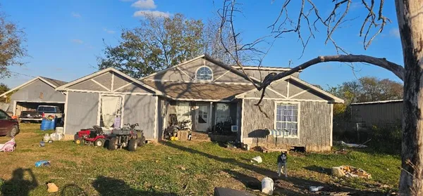 a view of a house with yard and sitting area