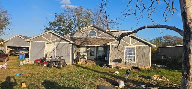 a view of a house with yard and sitting area