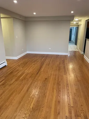 a view of a room with wooden floor