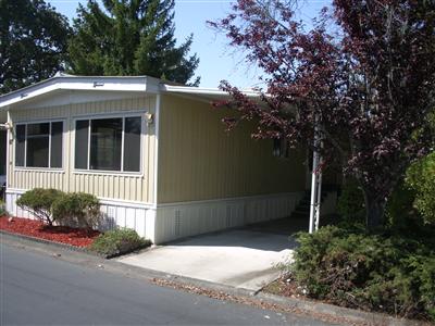 67 Cardinal Way, Unit 24 Santa Rosa, CA 95409 - Photo 2 of 11 a front view of a house with a yard and garage