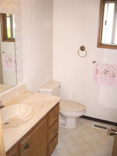 67 Cardinal Way, Unit 24 Santa Rosa, CA 95409 - Photo 9 of 11 a bathroom with a granite countertop sink mirror vanity and toilet