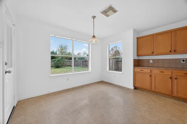 a open kitchen with granite countertop cabinets and white appliances