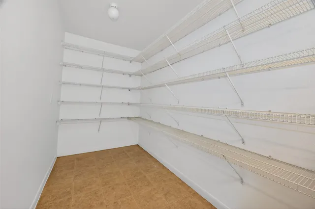 a view of a kitchen with dishwasher cabinets and a window