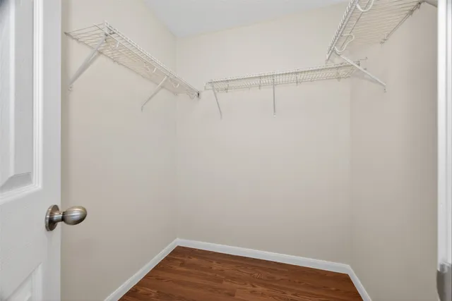 a view of room with wooden floor and ceiling fan