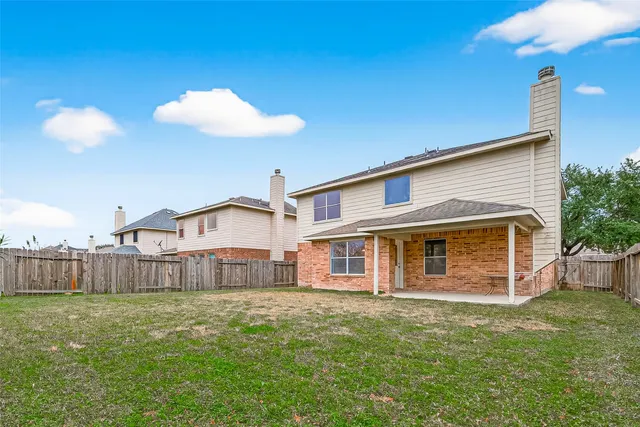 a view of a house with a yard and sitting area