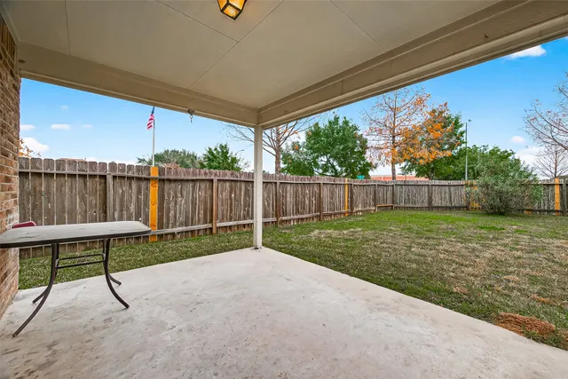 a view of house with backyard and garden