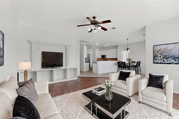 a living room with furniture a flat screen tv and a fireplace