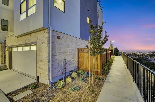 a view of balcony with wooden floor and fence