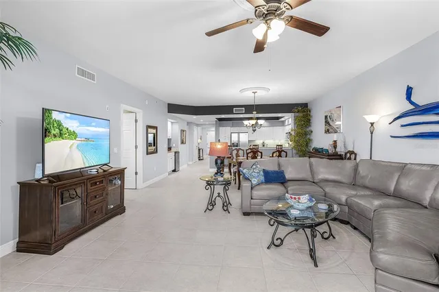 a view living room with granite countertop kitchen island white cabinets and a granite counter tops