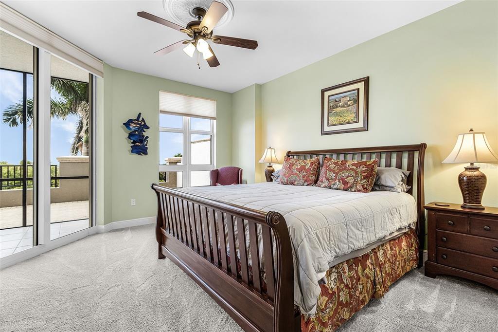 3333 Sunset Key Circle, Unit 103 Punta Gorda, FL 33955 - Photo 23 of 58 a bedroom with a bed and a chandelier