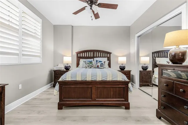 a view of a swimming pool with a table and chairs potted plants