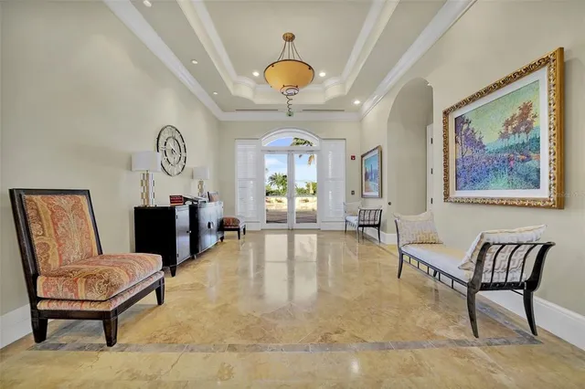 a living room with furniture a flat screen tv and large window