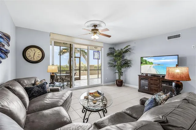 a living room with furniture a clock and a window
