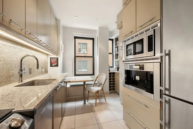 a kitchen with stainless steel appliances granite countertop a sink and cabinets