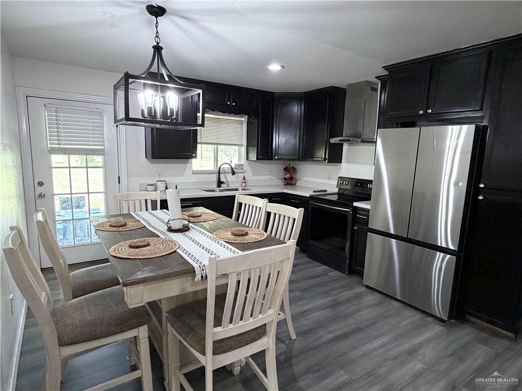 4204 Lott Road Donna, TX 78537 - Photo 5 of 28 Kitchen featuring dark cabinetry, white countertops, stainless steel appliances, and wood-finish flooring