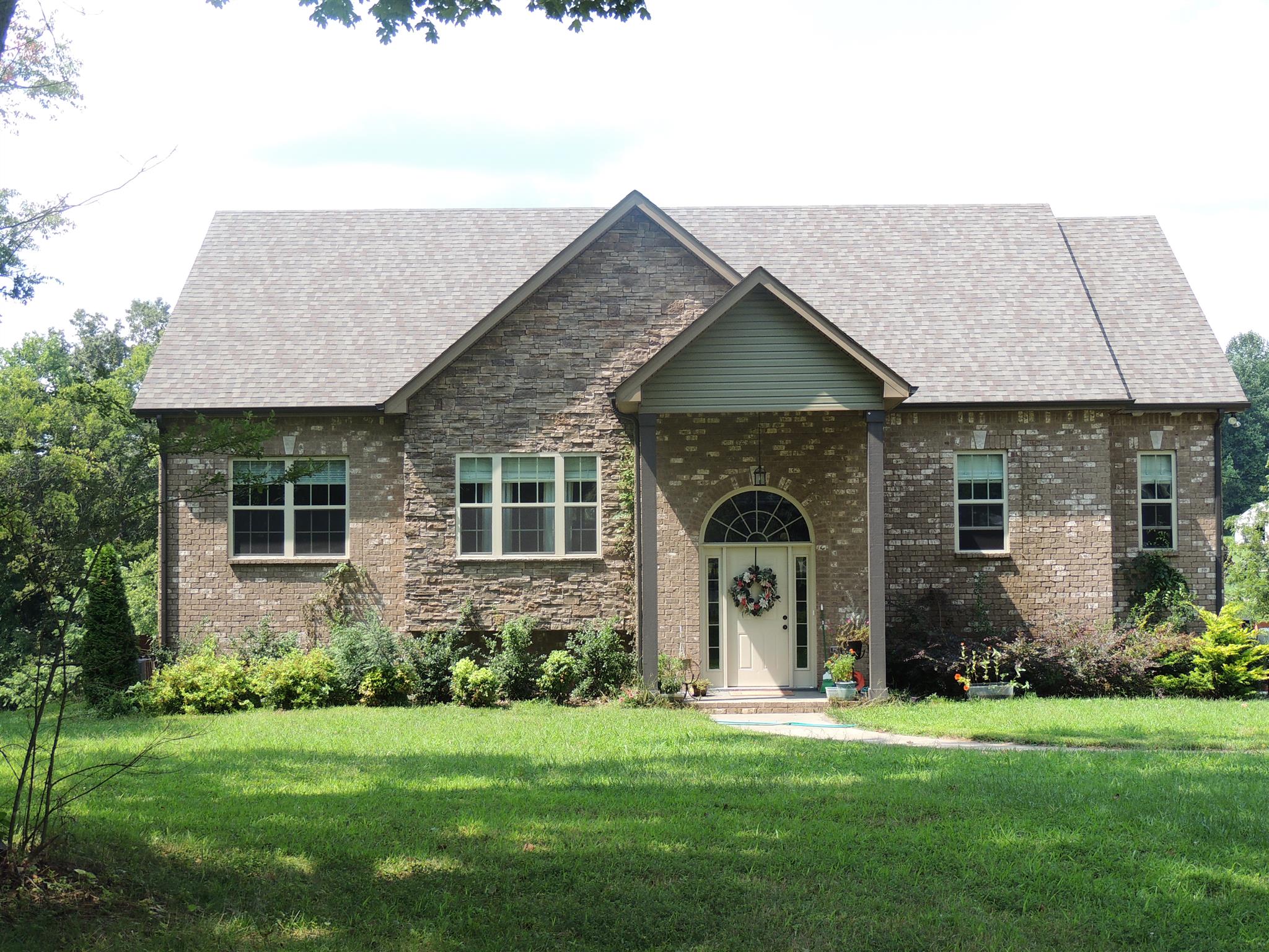3172 Marthas Chapel Road Cunningham, TN 37052 - Photo 1 of 29 a front view of a house with a garden