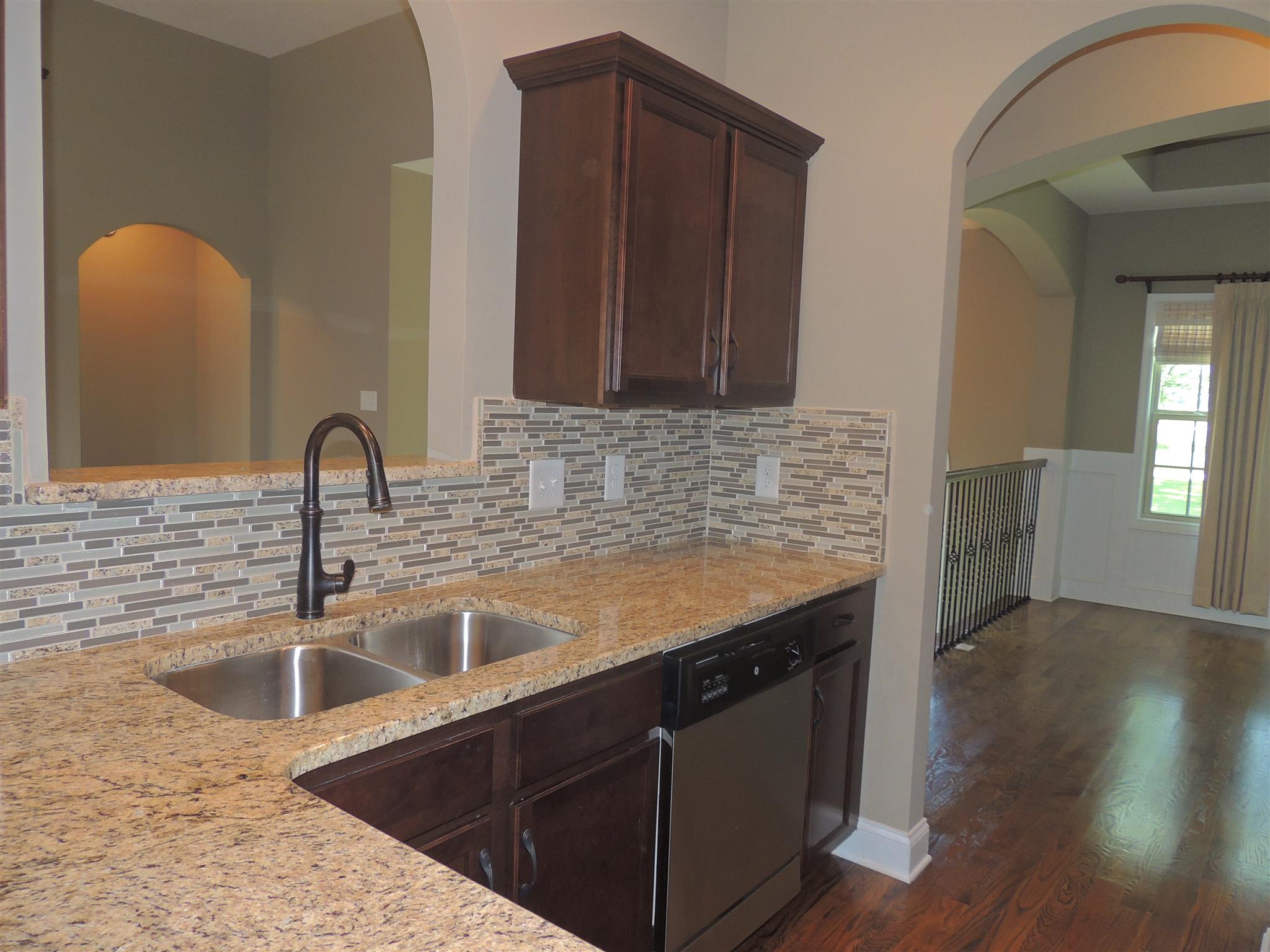 3172 Marthas Chapel Road Cunningham, TN 37052 - Photo 11 of 29 a kitchen with granite countertop a sink and wooden cabinets