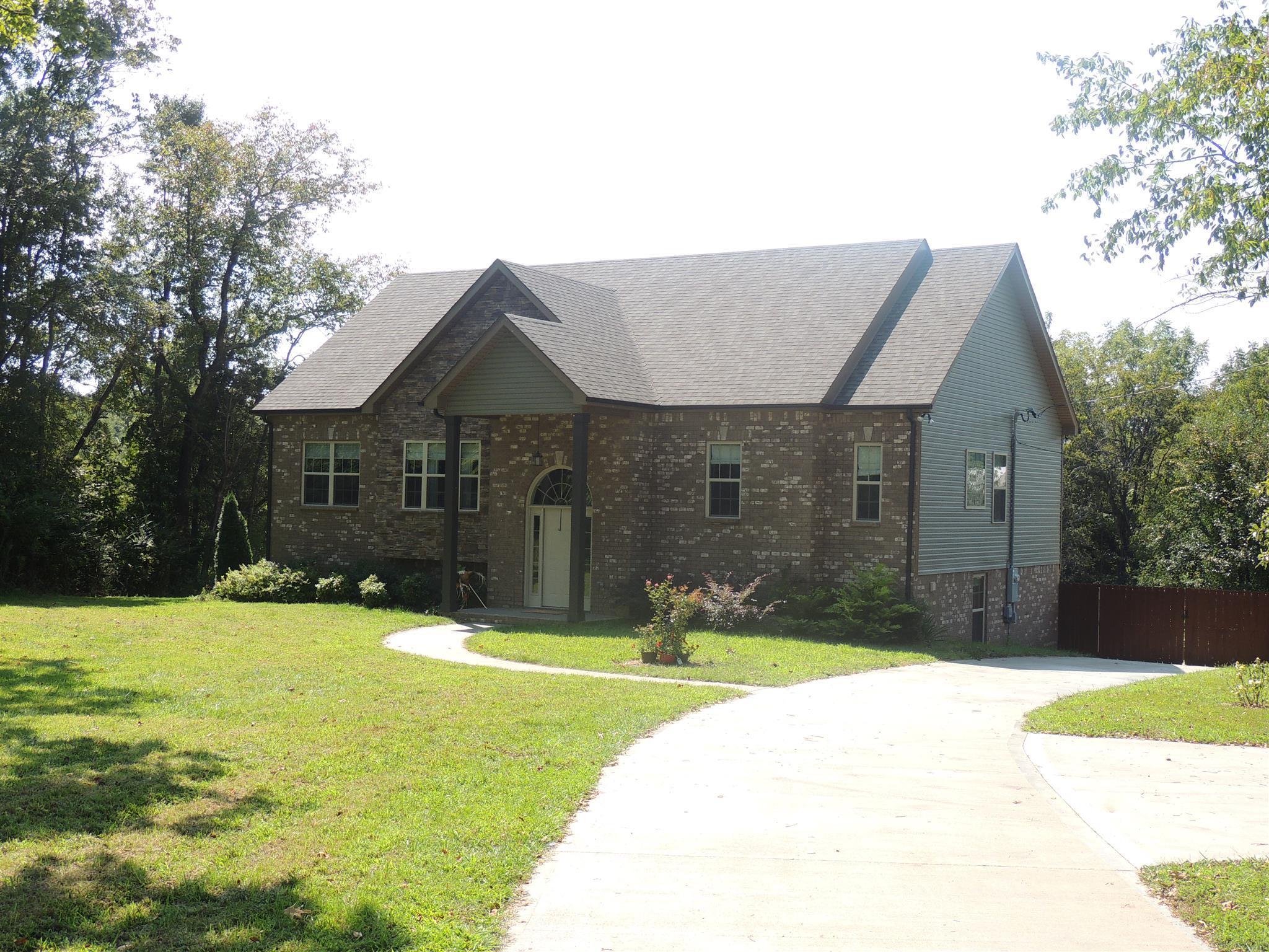 3172 Marthas Chapel Road Cunningham, TN 37052 - Photo 7 of 29 a front view of a house with a yard
