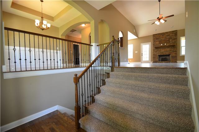 3172 Marthas Chapel Road Cunningham, TN 37052 - Photo 8 of 29 a view of staircase with yellow lighting