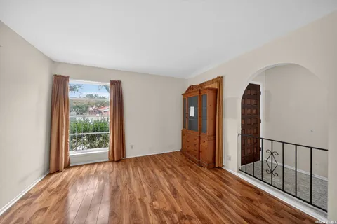 a view of hallway with wooden floor and stairs