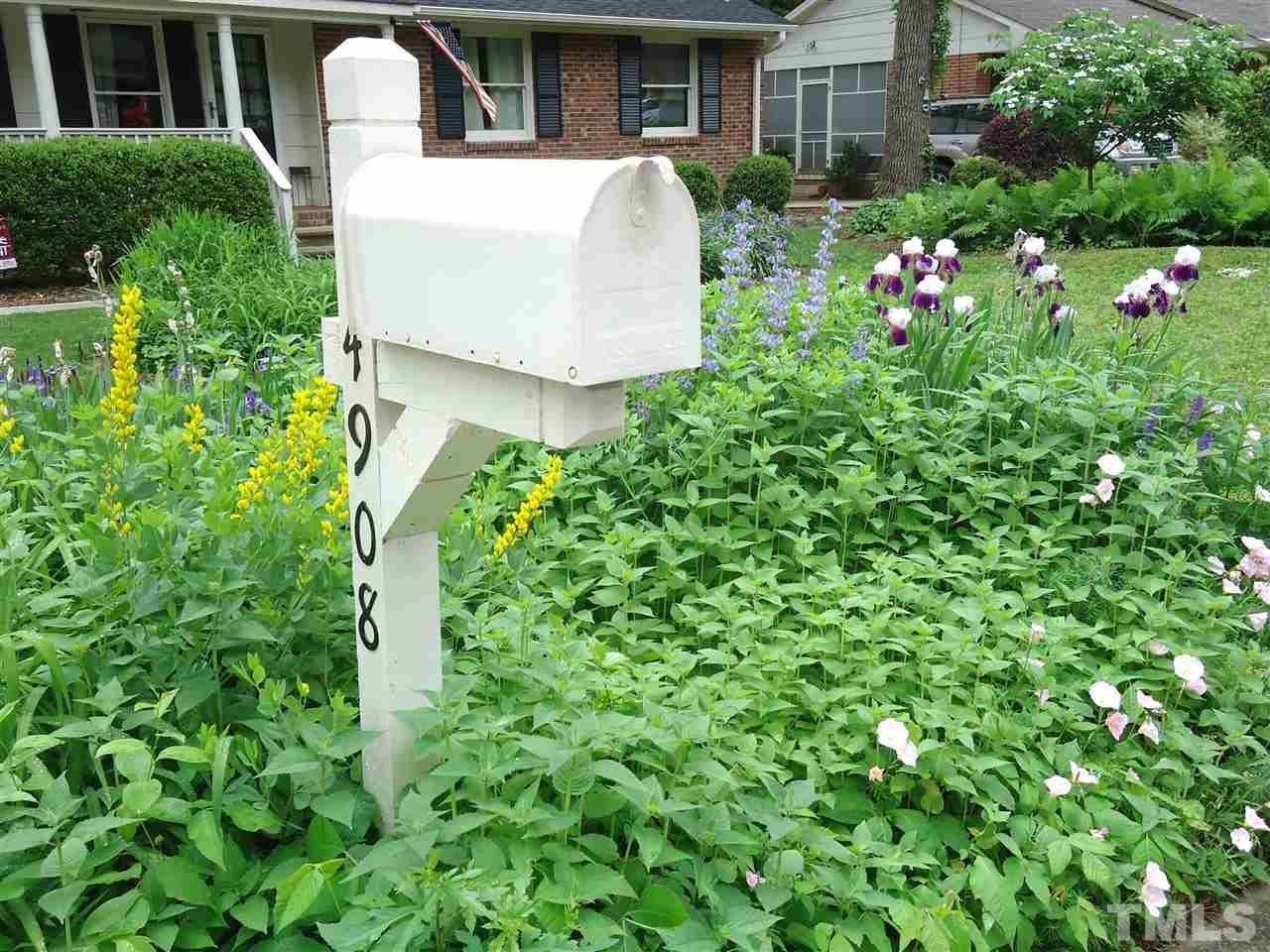 4908 Auburn Road Raleigh, NC 27609 - Photo 3 of 25 a view of a house with a yard and garden