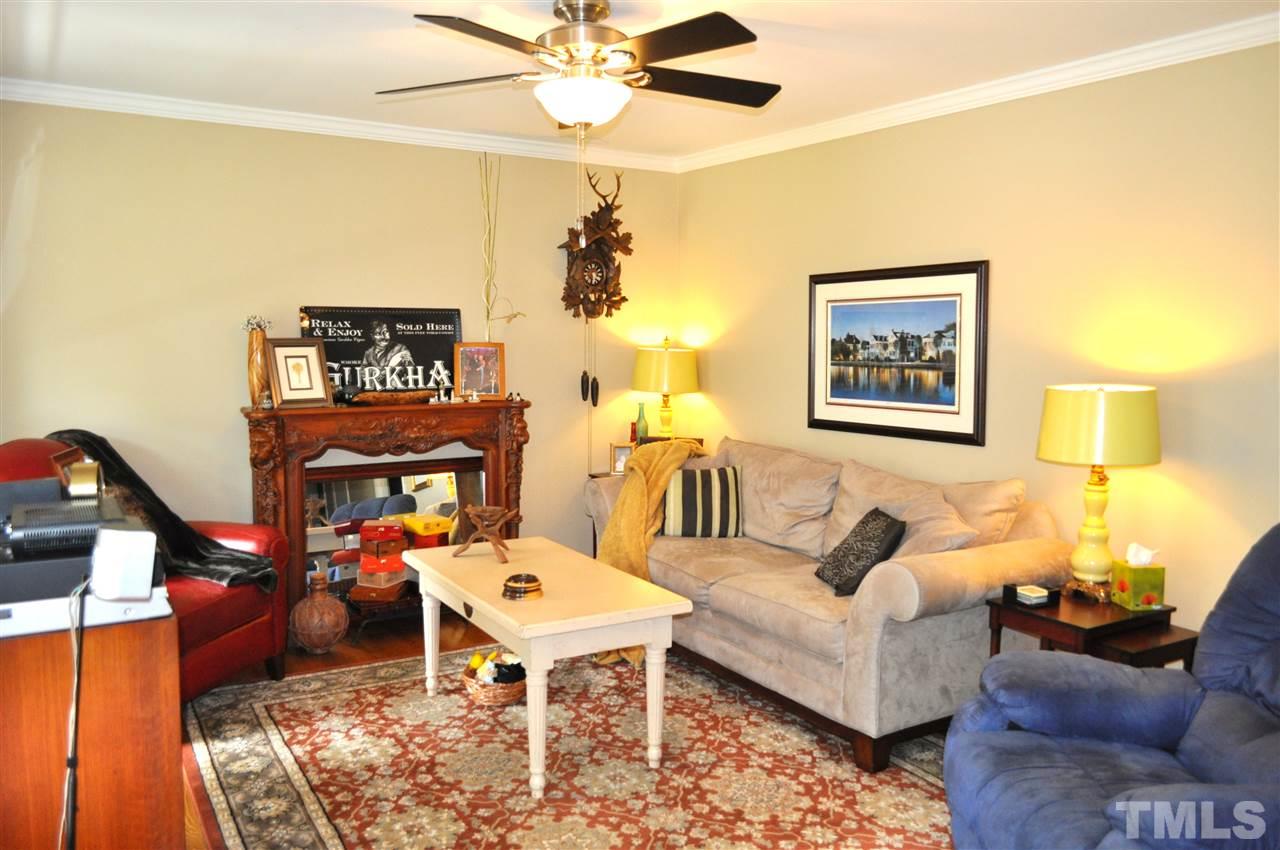 4908 Auburn Road Raleigh, NC 27609 - Photo 5 of 25 a living room with furniture and a chandelier