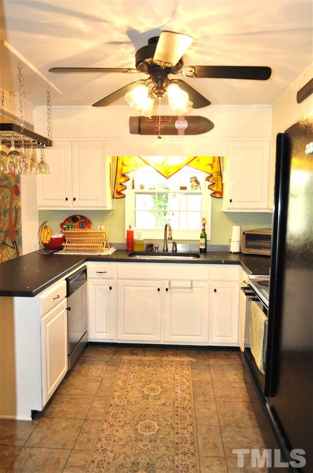 4908 Auburn Road Raleigh, NC 27609 - Photo 9 of 25 a kitchen with stainless steel appliances a stove and more cabinets
