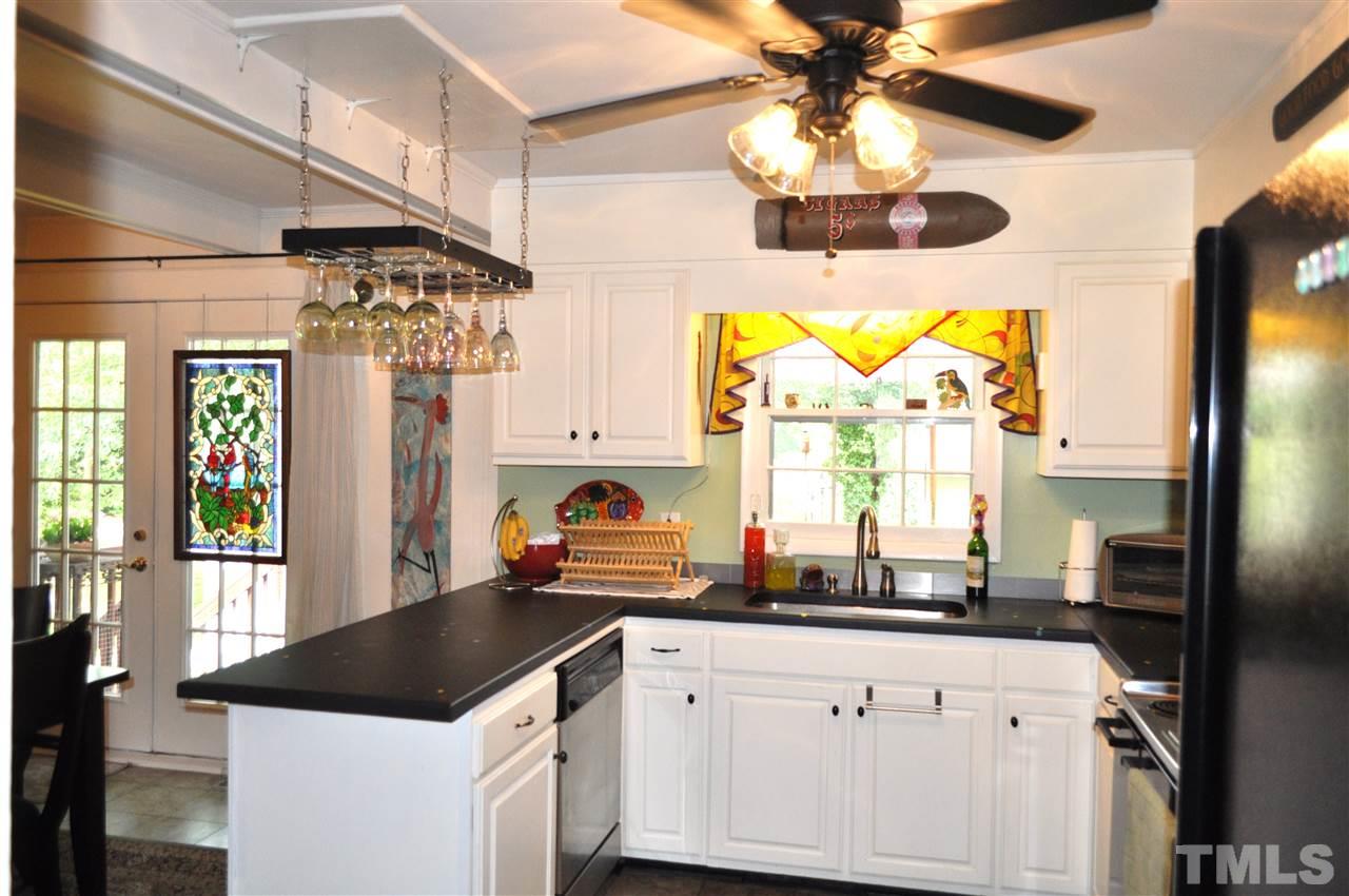4908 Auburn Road Raleigh, NC 27609 - Photo 10 of 25 a kitchen with a window a sink and cabinets