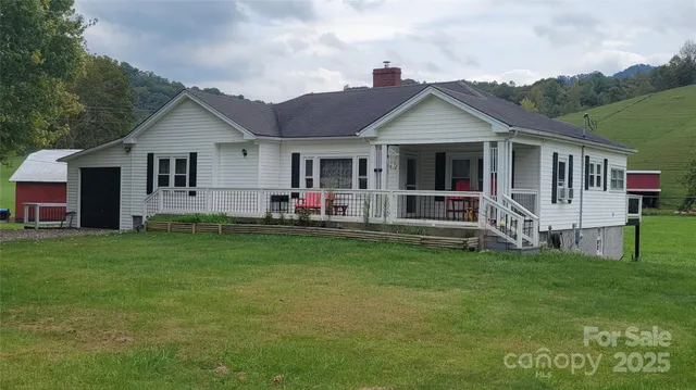 a view of a house with a yard and sitting area