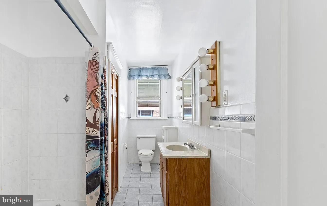 2329 Rhawn Street Philadelphia, PA 19152 - Photo 19 of 23 a bathroom with a granite countertop sink a mirror and a shower