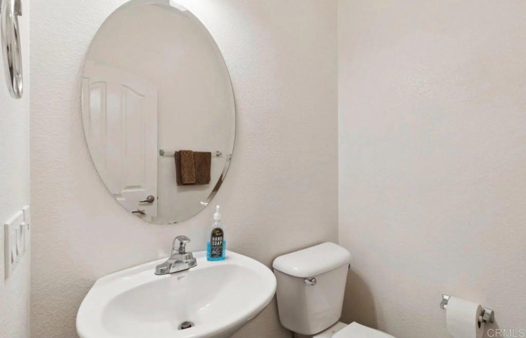 1234 Old Janal Ranch Road Chula Vista, CA 91915 - Photo 33 of 34 a bathroom with a toilet sink and mirror