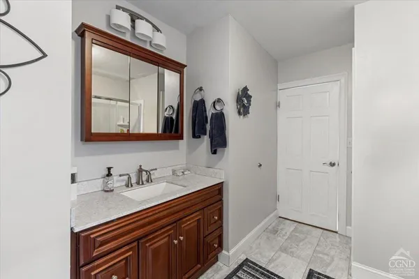 a bathroom with a sink a vanity and a mirror