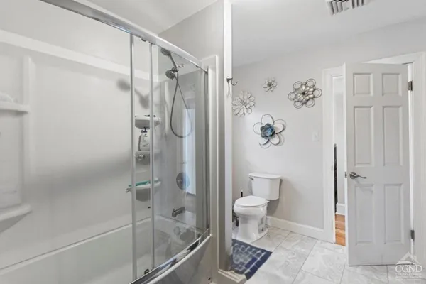 a bathroom with a glass shower door