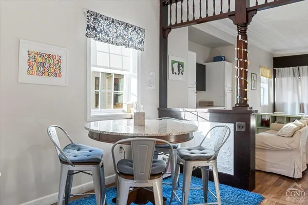 a dining room with furniture and wooden floor