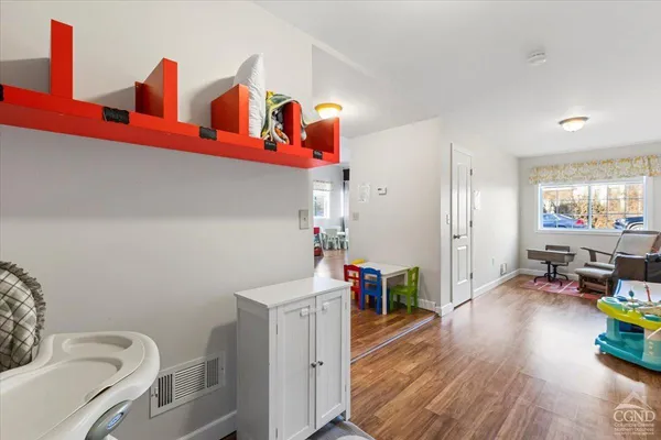 a bedroom with furniture and a wooden floor