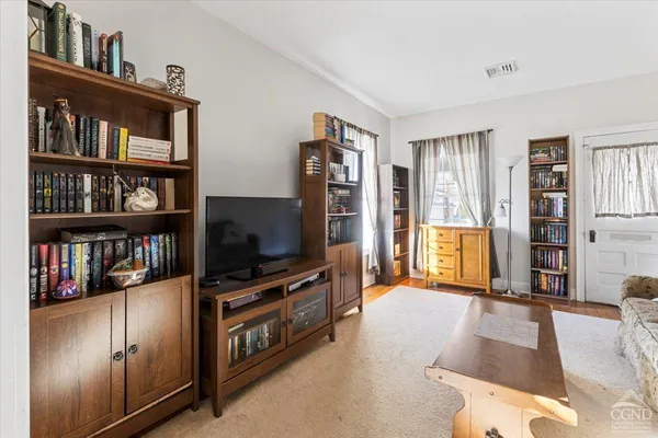 a living room with television and a flat screen tv