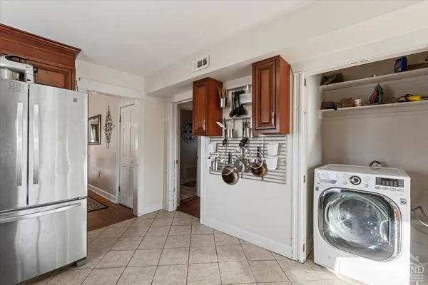 a view of a kitchen with refrigerator and washer