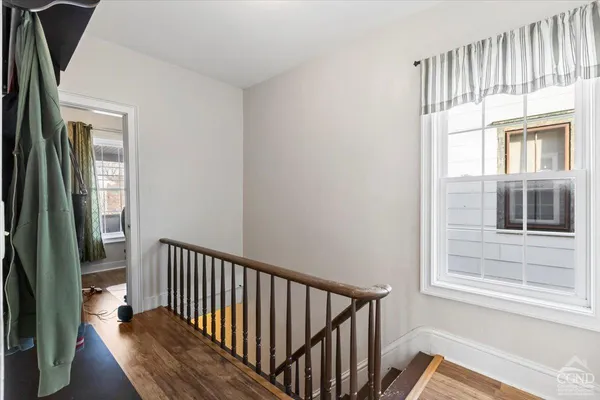 a view of staircase with wooden floor and a window
