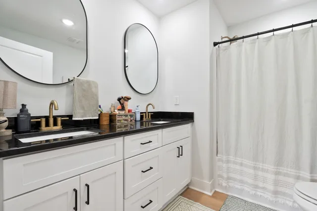 a bathroom with a double vanity sink and a mirror