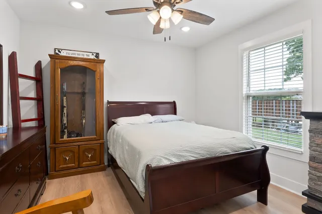 a bedroom with a bed and a chandelier