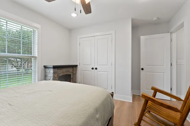 a bedroom with a bed and a window