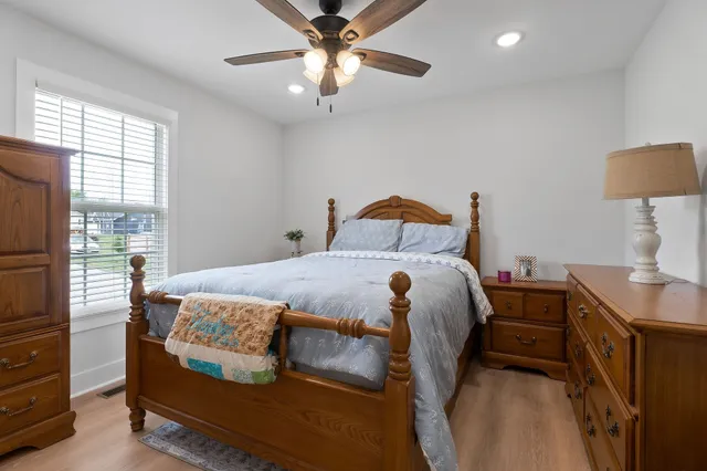 a bedroom with a bed and a chandelier