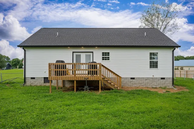 a aerial view of a house with a yard and deck