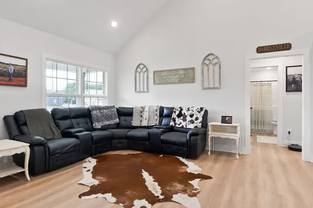 a living room with furniture and wooden floor
