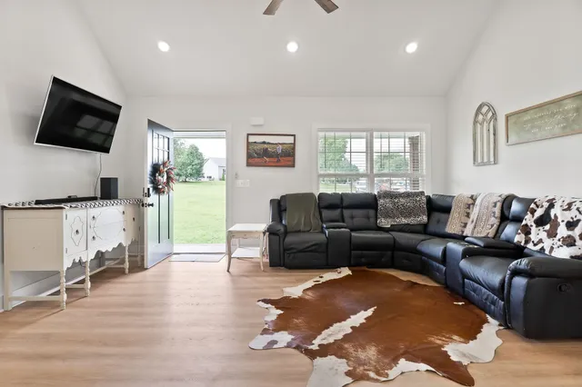 a living room with furniture and a flat screen tv