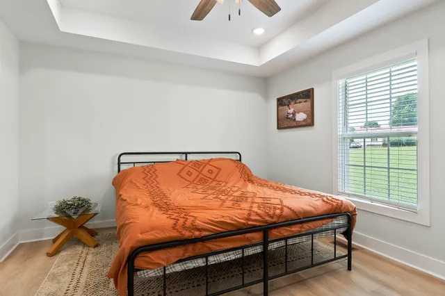 a bed sitting in a bedroom next to a window