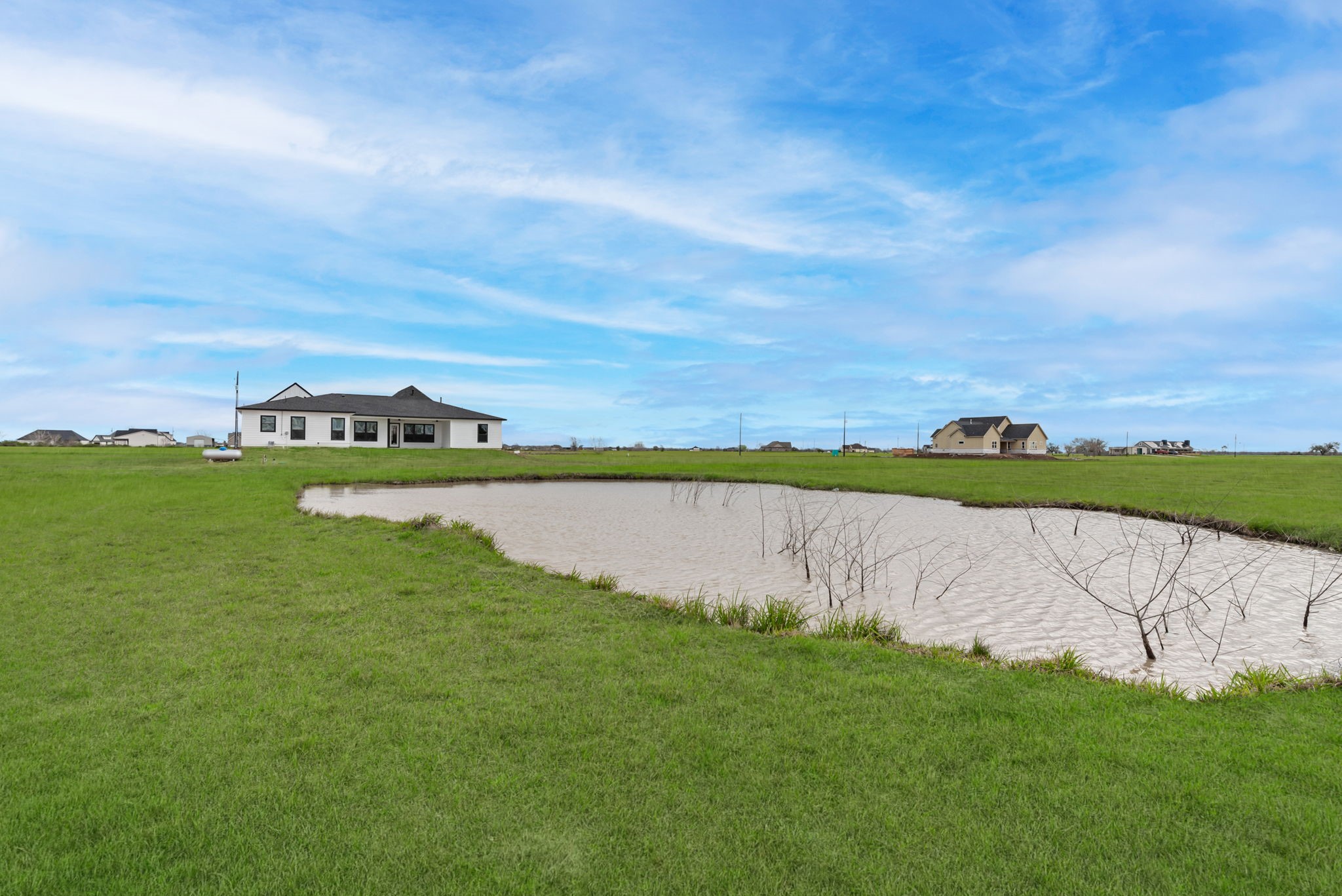 519 Chuckwagon Trail Angleton, TX 77515 - Photo 34 of 34 a view of a lake with houses in the back